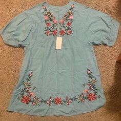 Adorable Top By Futurino. This Is Nwt (New With Tags). Size Medium. Short Sleeves. Three Buttons At The Front Neck. Beautiful Embroidered Flower Detailing. Longer, Roomier Style. Light Blue Embroidered Summer Blouse, Blue Short Sleeve Embroidered Top For Spring, Blue Embroidered Short Sleeve Top For Spring, Spring Blue Embroidered Top With Floral Details, Blue Embroidered Short Sleeve Top For Vacation, Light Blue Floral Embroidery Tops For Vacation, Vacation Blue Embroidered Cotton Top, Spring Blue Embroidered Top With Embroidered Hem, Spring Blue Embroidered Top With Hem Detail