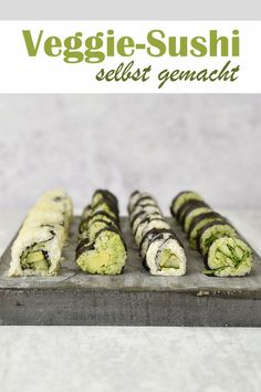 sushi rolls are lined up on a plate with the words veggie - sushi seltst genach