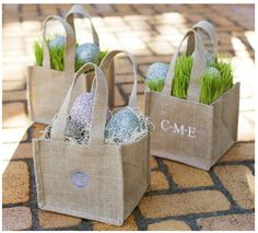 three bags with easter eggs in them sitting on the ground