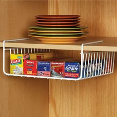 a kitchen shelf with plates and bowls on it