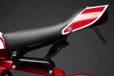 a red and white motorcycle seat on a black background