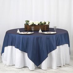 two plates on a table with white flowers