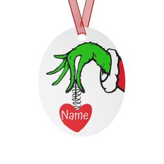 a round ornament with a green hand holding a red heart and name on it