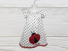 A pretty peasant polka dots girls dress with a ladybug to celebrate her birthday, school days, summer outings or as an every day dress.  Ladybug embroider applique.  Name and Age can be added. Dress is done in a cotton fabric. This dress has an oval neckline, which is gathered with elastic, short flutter sleeves.  The dress is easy to pull on and off.  All seams have been professionally finished with a serger . Dress is roomy enough to wear over a long sleeve top and leggings during the chilly weather.  Measurements are taken from shoulder to hem Size 12 Months - 17" Size 18 months - 18" Size 2T - 19" Size 3T - 21" Size 4T - 22" Size 5 - 24" Size 6 - 26"  (  Please keep in mind that as these are handmade items measurements may slyly vary by 1/2 inch. ) All our items are handmade and made t Cute Polka Dot Dress For Birthday, Ladybug Dress, Ladybug Birthday, A Ladybug, Birthday Dress, Dress Girls, School Days, Girls Dress, Flutter Sleeve