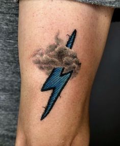 a woman's arm with a lightning tattoo on it