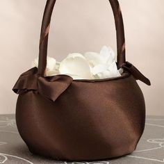 a brown purse with white flowers in it