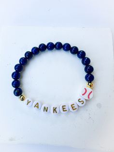 Buy ANY two or more items & get 20% off automatically applied at checkout ❤️ Use code BULK30 for orders of 10 or more for 30% off. Message me for the availability of 20 or more of one item. Please select your suitable size in the drop down menu. Listing is for ONE bracelet. Please ensure correct selections before checkout, and please feel free to send a message if you have any further questions or if you received a damaged package.  Made with 6mm Lapis Lazuli natural stone beads. We take special Baseball Bracelet, Mlb World Series, Yankees Fan, Bracelet Stone, Lapis Lazuli Beads, Yankees Baseball, Natural Stone Beads, Ny Yankees, Wood Bridge