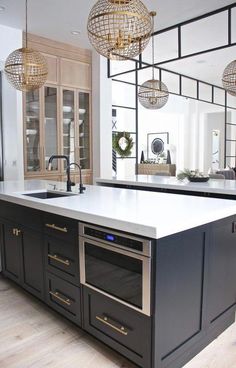 a kitchen with an island, sink and oven in it's centerpieces