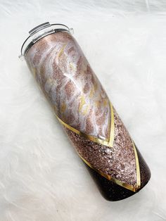 a bottle that is sitting on top of a white fur covered floor with gold trim