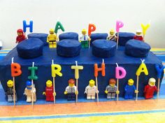 a birthday cake with lego figures on it