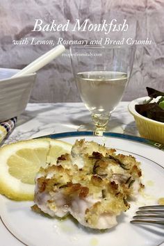 a white plate topped with food next to a glass of water