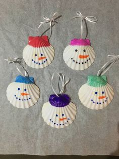 four seashell ornaments with snowmen on them