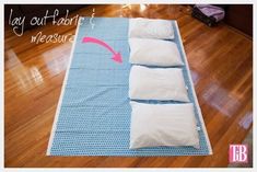 four pillows laid out on top of a blue mat with the words lay out fabric measure