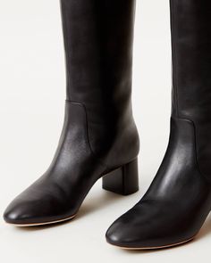 Tall shaft boot with mid-heel in black soft calf leather. Padded footbed with gold stamped logo. Almond toe, pulls on. 2 inch heel. Flat Tall Black Boots, Classic High Ankle Boots With Sculpted Heel, Classic Boots With Block Heel And Medium Width, Classic Boots With Block Heel Medium Width, Classic Medium Width Boots With Block Heel, Classic Wide Calf Low Heel Boots, Classic Wide Calf Heeled Boots With Low Heel, Business Low Heel Boots Medium Width, Wide Calf Leather Sole Boots With Block Heel