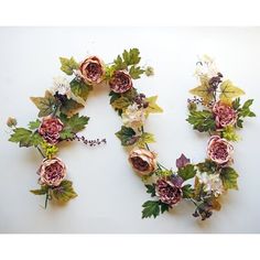 the letter o is made up of flowers and leaves