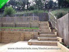 wooden steps leading up to a garden area