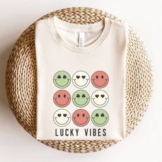 a white t - shirt that says lucky vibes with smiley faces on the front