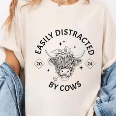 ABOUT OUR " highland cow shirt designs " PRODUCT FEATURES. - Medium weight fabric (6.1 oz/yd²). - 100% combed and banded cotton. - Relaxed fit and crew neck. - Double-stitched for durability. - Pre-shrunk fabric. CARE INSTRUCTIONS - Machine wash in cold water with like colors. - Use mild detergent. - Tumble dry or air dry low. - Iron on medium heat if necessary. - Do not bleach or dry clean. HOW TO ORDER PRODUCT  - Please review all photos. - Choose your style, color and size of sweatshirt or t-shirt.( Size chart is available in the product gallery. Please choose your size carefully) - Click "Add to cart". You can go back and follow the same steps to add more items to your cart. - Click "Proceed to checkout". - Add your shipping address and choose your shipping method (PLEASE verify your c Cow Shirt, Comfort Color, Highland Cow, Animal Lover, Cow, Halloween Shopping, Favorite Outfit, Shirt Designs, Relaxed Fit