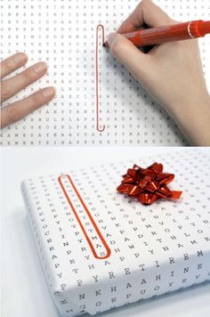 a gift wrapped in white paper with a red bow tied around it and someone's hand writing on the box