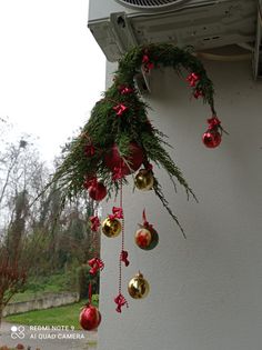 an air conditioner hanging from the side of a building with christmas decorations on it