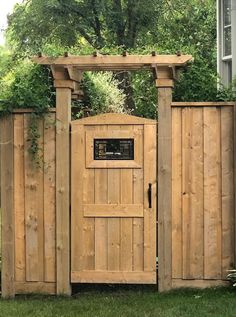 a wooden gate in the middle of a yard