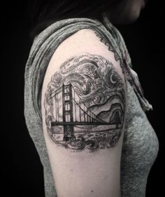 a woman's arm with a black and white drawing of the golden gate bridge