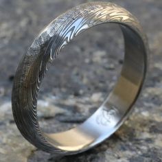 a wedding ring with an engraved design on it