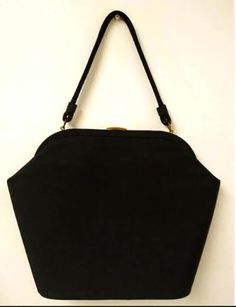 This is a wonderful, elegant, Black Fabric Handbag/Purse that was made in the late 1950s, early 1960s. It is lined in BLACK silky fabric with a layered slot pocket. No maker's mark or tag. The bag has a great trapezoid shape!  It is so much prettier in person. This is a LARGE purse, please check the measurements to assure that this bag will work for you. MEASUREMENTS: Total Height with handle: 18.0" Length: 11.0" (measured on bottom) Width: 4.0 " Depth: 11.0 " The purse has gold tone hardware, frame, and a fabric strap. The bag has a flat, rounded bottom. The purse closes securely with a gold tone metal clasp. The purse shows very little wear at all, and was stored well. No holes, stains, or tears detected. Please view all of the photos, as they are part of the description. COLORS MAY VARY Retro Black Bags For Vintage Events, Mid-century Black Bags For Vintage Style, Retro Vintage Black Evening Bag, Mid-century Style Black Bags, Retro Black Evening Bag, Elegant Black Bag For Vintage Fashion, 70s Mini Dress, Turquoise Purse, Fabric Refresher