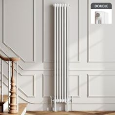 a white radiator in a room next to a stair case and wooden steps