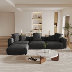 a modern living room with black couches and white rugs on the hardwood floor