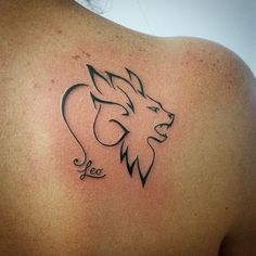 the back of a woman's shoulder with a lion tattoo on it