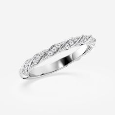 a white gold wedding ring with diamonds on the sides and an intricate design in the middle