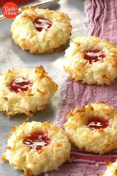 some biscuits with jam on them sitting on a towel