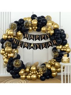 a black and gold happy new year balloon wreath