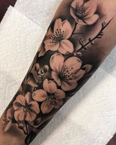 a black and white flower tattoo on the arm