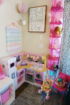 a child's play kitchen with pink accessories