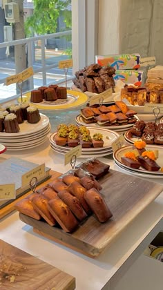 a table filled with lots of different types of pastries and desserts on plates