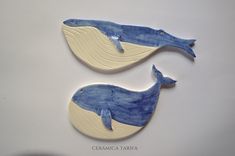 two blue and white whale shaped ceramic pieces