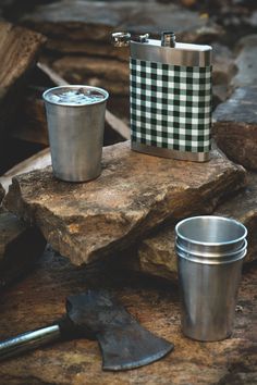 a flask with a cup next to it on top of a wooden log and the words wow - to