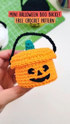 a crochet halloween basket with a pumpkin face on it