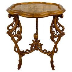 an ornate wooden table with glass top