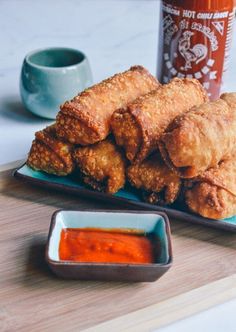 some fried food is on a plate with dipping sauce