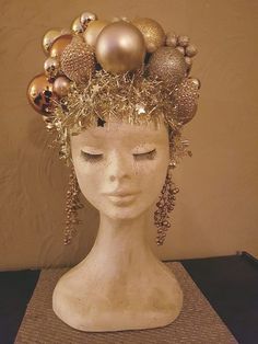 a white mannequin head with ornaments on it