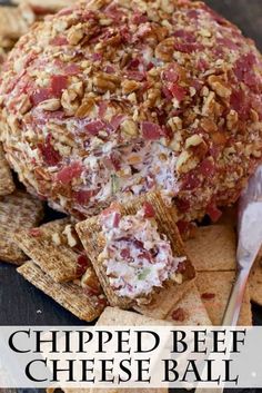 a cheese ball with crackers and other snacks on the side that says, chipped beef cheeseball