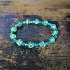 This delightful shimmering bracelet is made with 8mm and 4mm round glass beads with a crackle effect. It is great for stacking or can be worn on its own. It measures 7 inches in length, which fits an average size wrist. Great care has been taken to ensure that your bracelet has been assembled securely. However, please keep in mind the nature of elastic cord and take care not to over-stretch your bracelet and risk breakage. To extend the life of your bracelet and keep the beads from fading, avoid contact with water, sweat, chemicals, or prolonged direct sunlight. Please message me with any questions. To see other bracelet options, check out my full store: https://www.etsy.com/shop/shopcraftyoctopus/ Glass Bead Bracelet, Blue Sparkle, Fancy Beads, Blue Sparkles, Crackle Glass, Knoxville Tn, Glass Beaded Bracelets, Bracelet Stack, Bead Bracelet