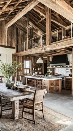 an open kitchen and dining area with wooden beams on the ceiling, wood table surrounded by chairs