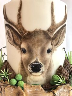 a close up of a cake with a deer head on it