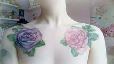 a woman's chest with pink and purple roses on it