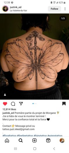 the back of a woman's body with tattoos on it