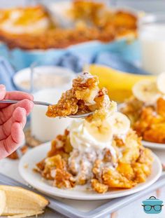 a person is holding a spoon over a plate of food with bananas and ice cream on it